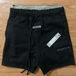 New Medium Fear of God Essentials Black Reflective Logo shorts